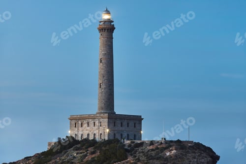Preview: Cabo de Palos stone lighthouse at sunset. Mediterranean coastline, Spain