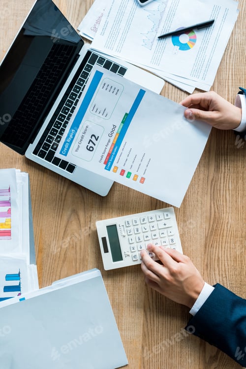 Preview: top view of businessman holding document with letters near calculator and laptop