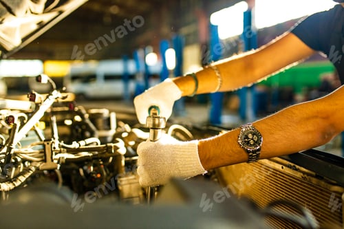 Preview: indian man auto mechanic working indoors in car shop