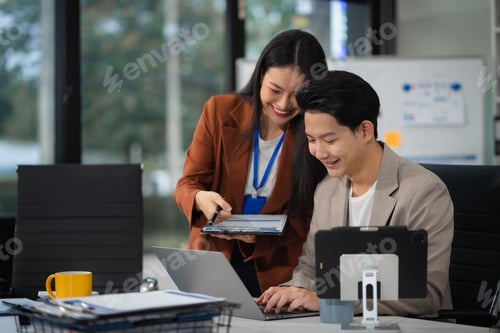 Preview: Business team working on a project in the office or reviewing and discussing a business project.