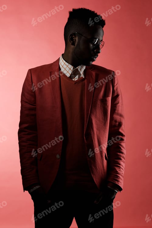 Preview: Stylish Black Man in Red Suit Posing in Studio