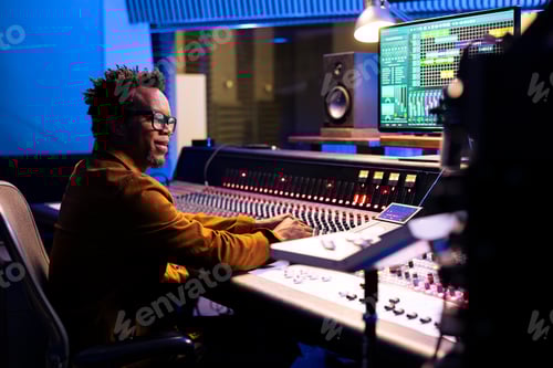 Preview: African american sound designer operating audio software to edit tracks