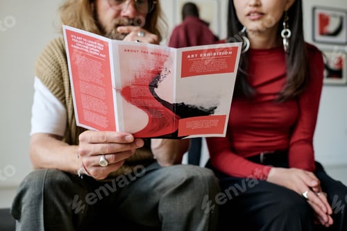 Preview: Discussing Art Exhibition Pamphlet While Sitting Together