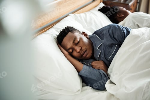 Preview: A man sleeping soundly in bed