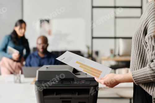 Preview: Unrecognizable Woman Printing Documents In Modern Office