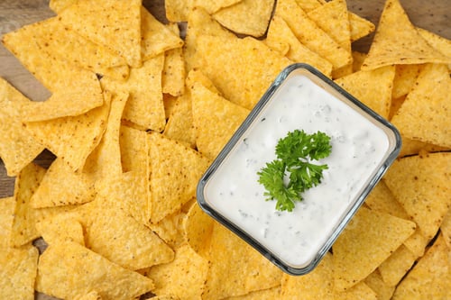 Preview: Mexican nacho chips with sauce on table, top view