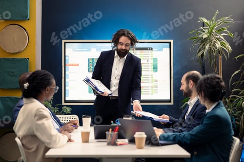 Preview: Group manager distributes papers with current statistics on performance