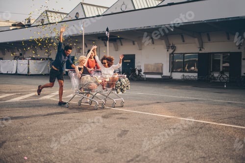 Preview: Friends racing with shopping carts on road