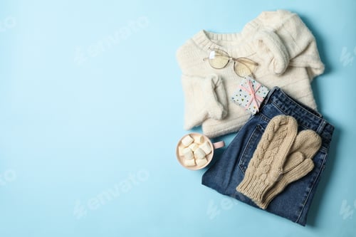Preview: Winter concept with sweater and gift box on blue background