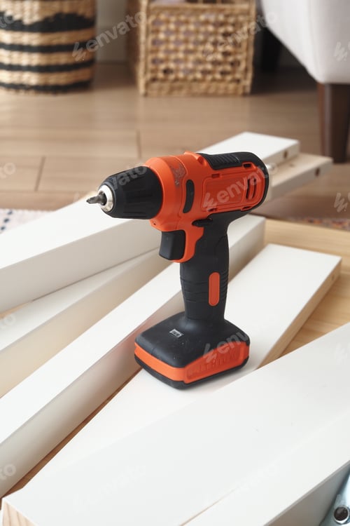 Preview: Power drill placed on wood pieces for home project