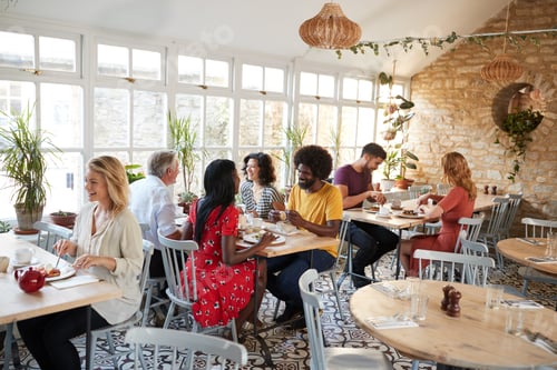 Preview: Customers eating at a busy restaurant in the day time