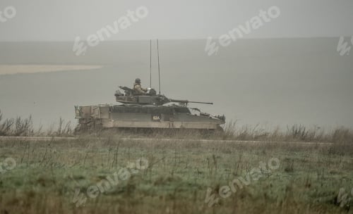 Preview: Military tank and soldiers with guns on a field