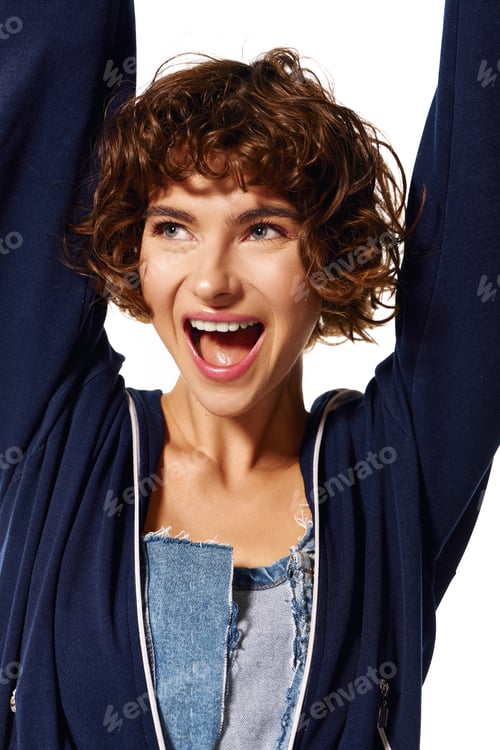 Preview: Joyful young woman expressing happiness in a stylish, casual outfit on a bright, cheerful day