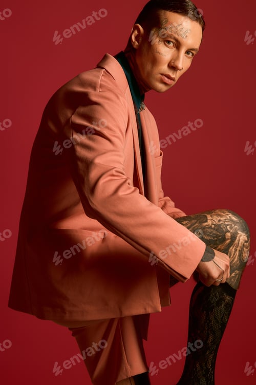 Preview: Handsome young man showcasing modern fashion in a vibrant and artistic setting