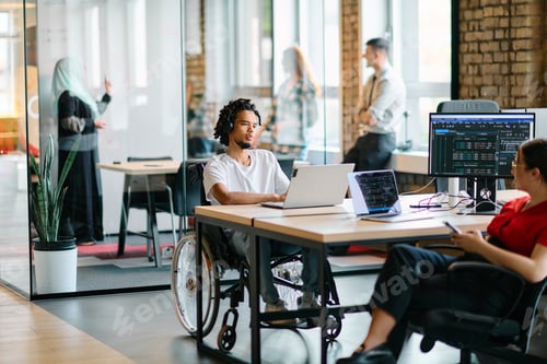 Preview: A young business group, including an African American businessman in a wheelchair, collaborates