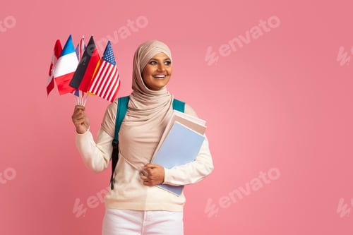 Preview: Study Abroad. Portrait Of Muslim Female Student With International Flags And Workbooks