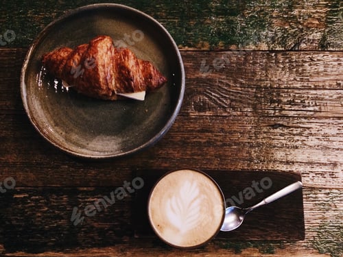 Preview: Coffee and Croissant on a Rustic Wooden Table