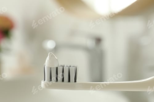 Preview: Brush with toothpaste in bathroom, closeup. Space for text