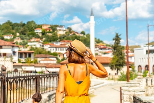 Preview: A young woman walking through the town of Berat in Albania on vacation, the city of thousand windows
