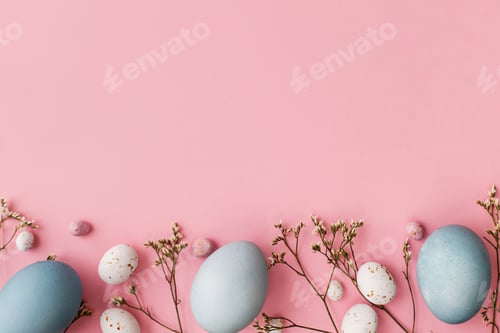 Preview: Easter eggs and flower flat lay on pink background with space for text. Modern greeting card