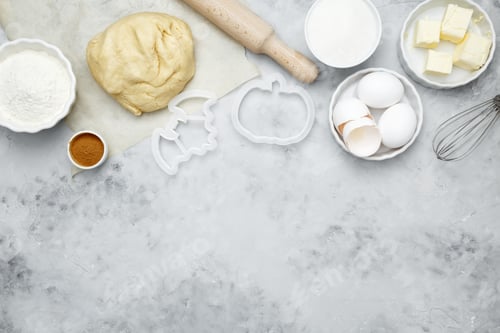 Preview: Baking ingredients including flour, butter, sugar, spices, eggs and pumpkin arranged
