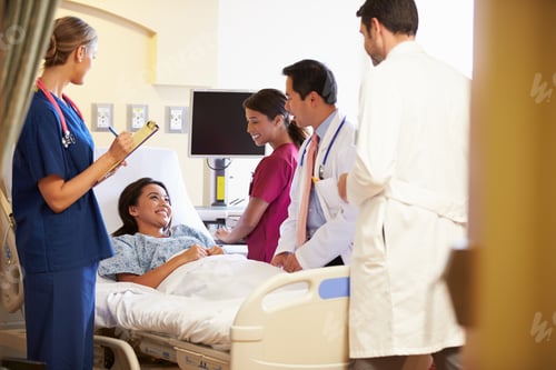 Preview: Medical Team Meeting Around Female Patient In Hospital Room