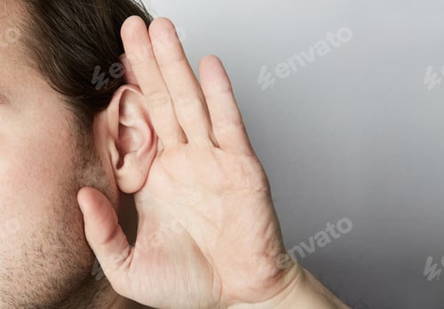 Preview: Portrait of young casual man which overhears conversation over white background.Closeup.
