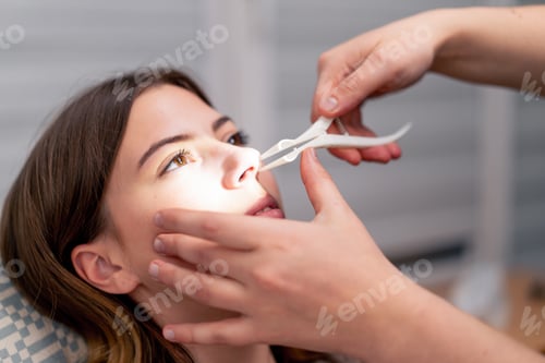 Preview: close-up ENT doctor examines the nasal cavity of the patient in the office clinic professional tools
