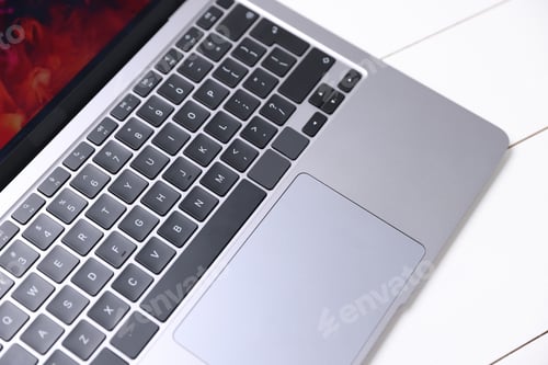 Preview: Laptop keyboard on white wooden table, above view