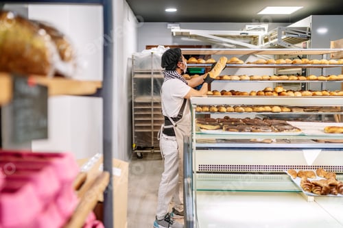 Preview: Latino baker shelving freshly baked bread