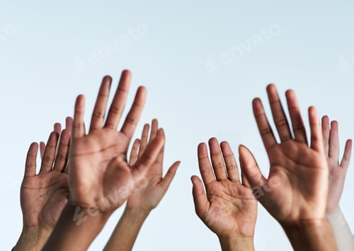Preview: Shot of a group of hands reaching up against a white background