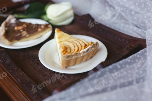 Preview: A piece of cake on a wooden tray