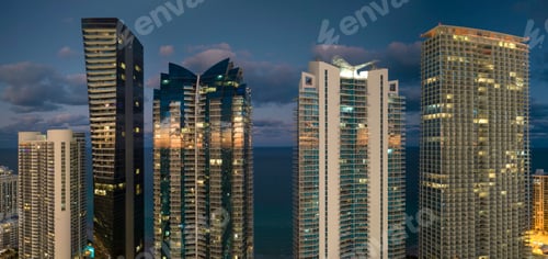 Preview: View from above of brightly illuminated high skyscraper buildings
