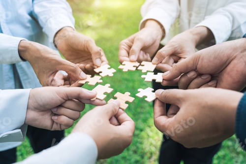 Preview: group of business people assembling jigsaw puzzle. The concept of cooperation