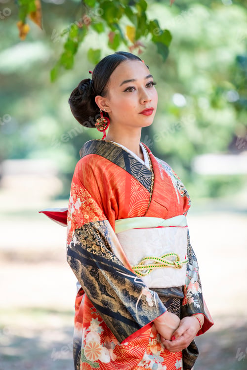 Preview: Elegant woman in traditional kimono admiring the serene park atmosphere.