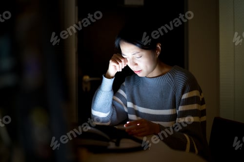 Preview: Woman feeling tried for looking on tablet