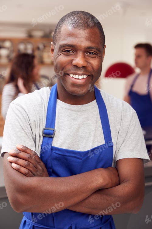 Preview: Portrait Of Smiling Man Wearing Apron Taking Part In Cookery Class In Kitchen