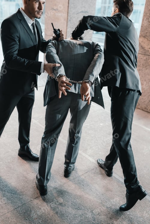 Preview: Cropped image of security guards arresting offender