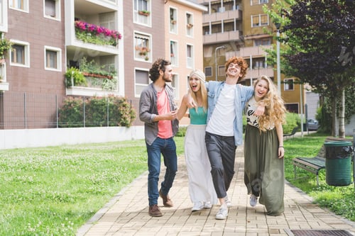 Preview: Friends enjoying a lively walk in a sunny urban park.