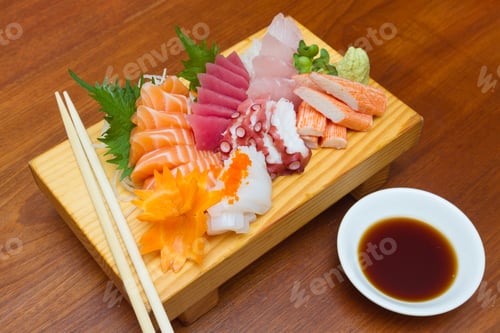 Preview: Sashimi (japanese food). Sliced raw seafood on wooden plate.