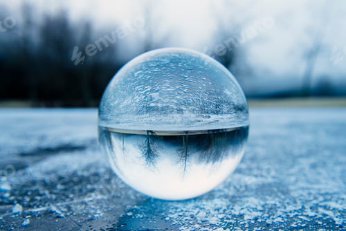 Preview: Close up of crystal ball on frozen lake