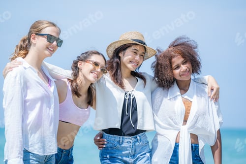 Preview: Happy women with friend are playing on the beach While relaxing on vacation.
