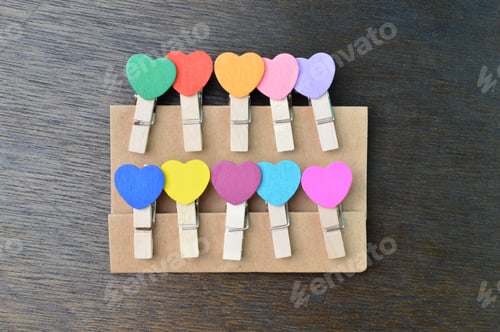 Preview: Colored wooden paper pegs on the table