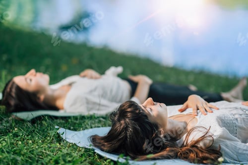 Preview: Women Reclining in a Meadow on Yoga Mats