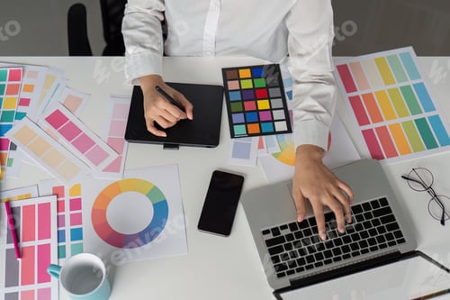 Preview: Creative Graphic Designer Working with Color Palettes and Digital Tools in Modern Office