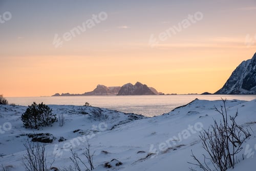 Preview: Scenery of mountain with snow pile on coastline in the evening on winter at Lofoten Islands