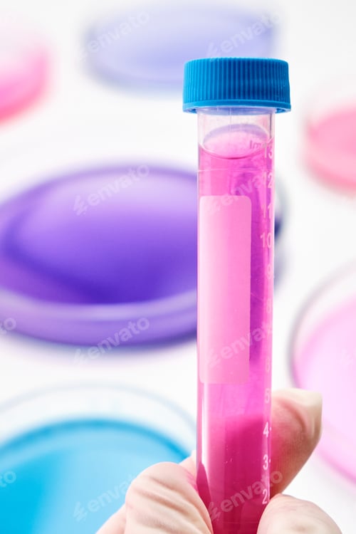 Preview: Test tube with blue liquid in the hand of scientist on the background of Petri dishes for