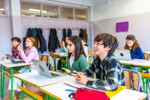 Preview: Students following lesson in classroom with laptops