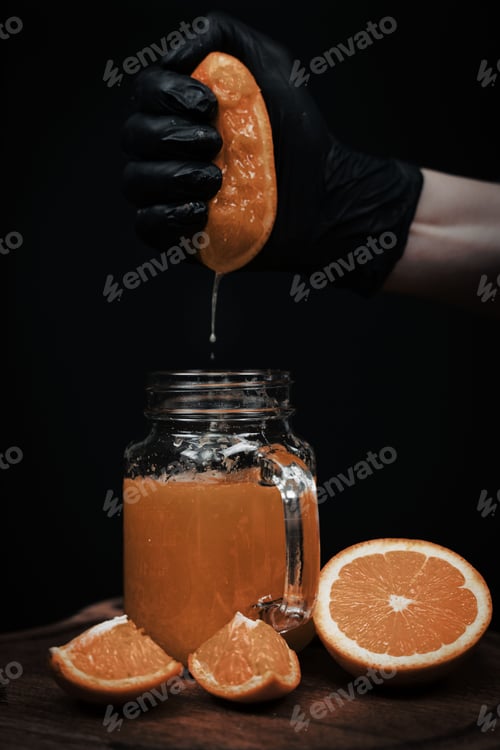 Preview: Chef crushing orange in glass