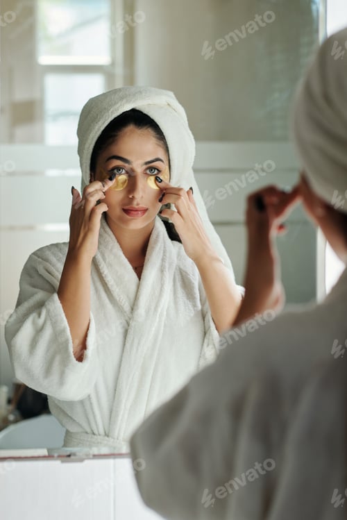 Preview: Woman Applying Brightening Eye Patches